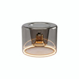 E27 LED-donutpære i røgfarvet glas, Ø 120 mm, tændt, varm lysring, hvid baggrund
